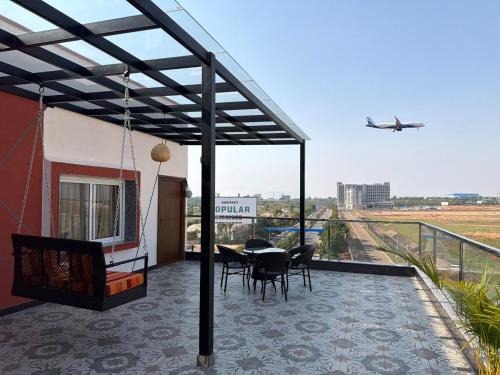 Devanahalli Apartment | Runway Retreat Rooftop Swing, Airport View