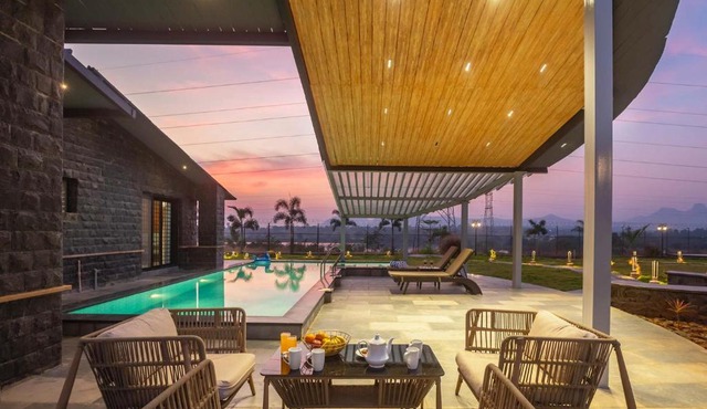 StayVista's Le Ciel - Lakeside Retreat Amidst Farmland with Pool, Indoor Activities, Lawn, Bonfire Pit & Ample Seating Space